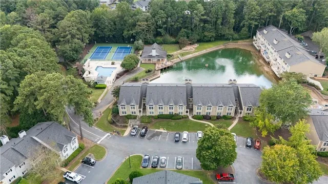 an aerial view of a house with a garden and lake view