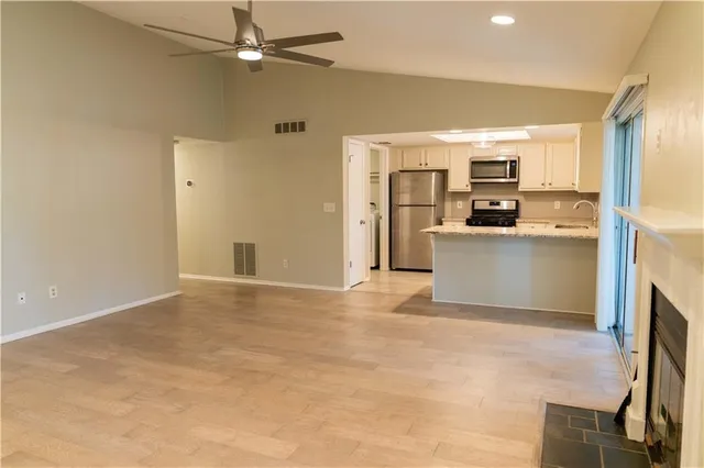 a view of a kitchen with a sink and a refrigerator
