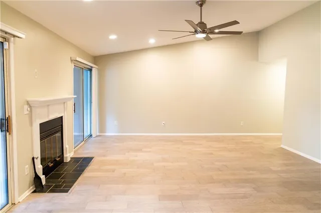 a view of an empty room with a fireplace
