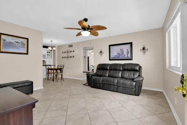 a living room with furniture and a dining table