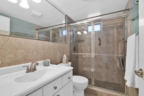 a bathroom with a sink toilet and shower
