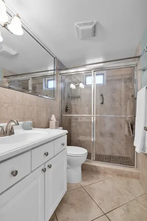 a bathroom with a shower sink and toilet