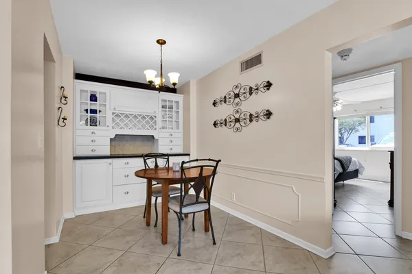 a view of dining room and kitchen with furniture wooden floor and a chandelier