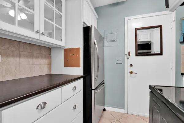 a kitchen with a refrigerator and cabinets