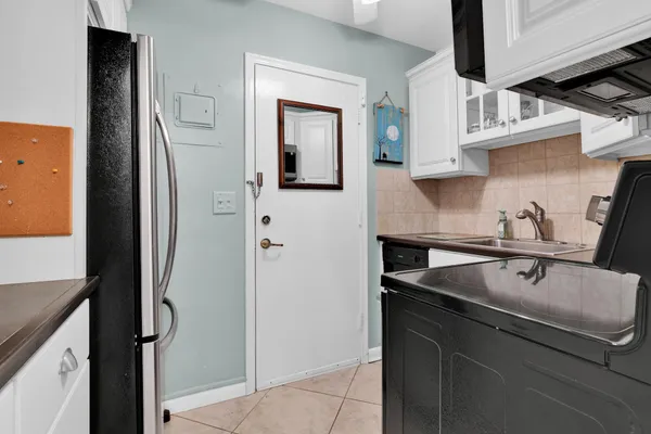 a kitchen with a sink and a refrigerator