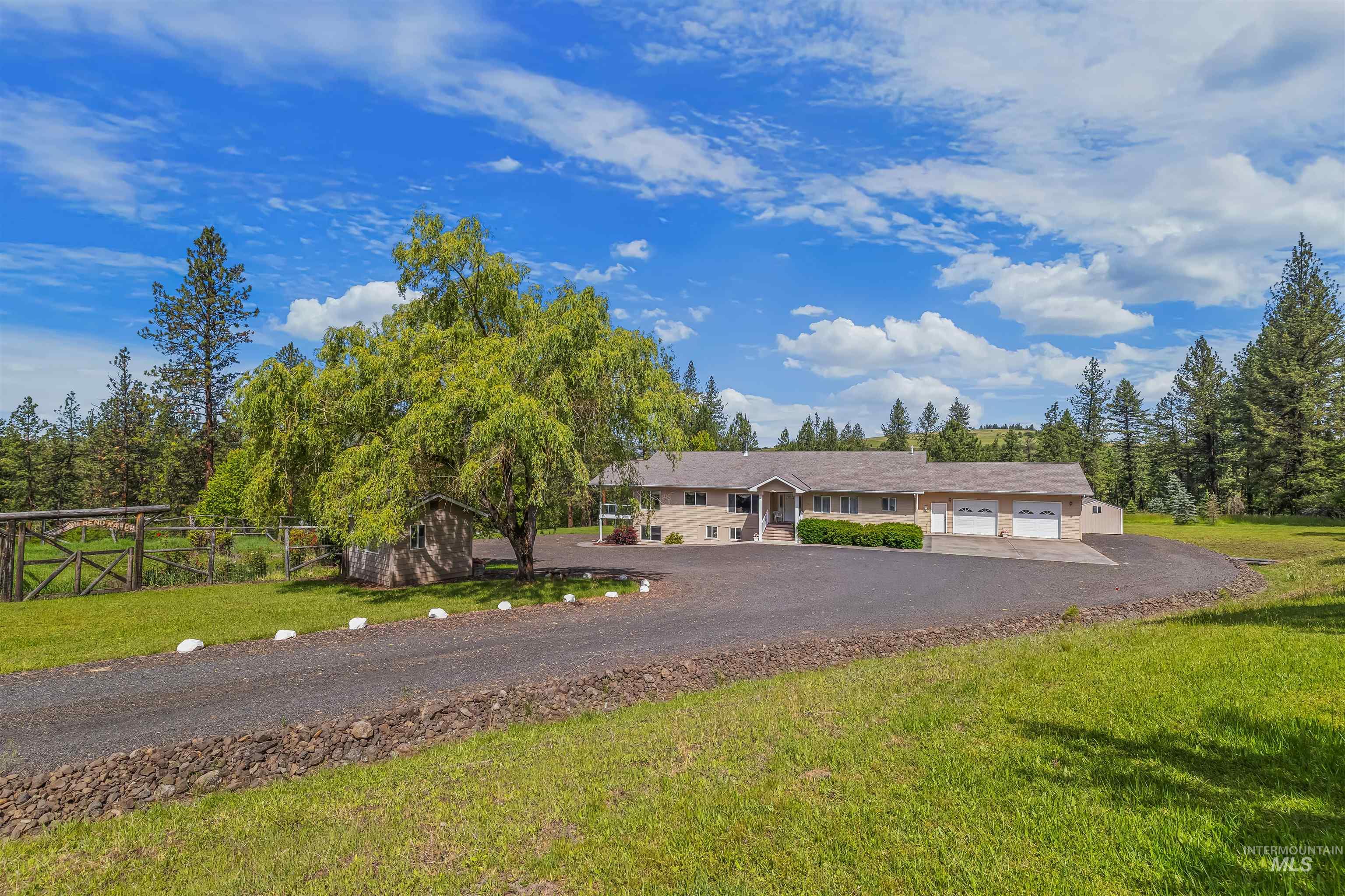 743 Wall Crk Road Stites, ID 83552 - Photo 5 of 48 Spacious ranch-style residence featuring a three-car garage, expansive paved driveway, and mature landscaping
