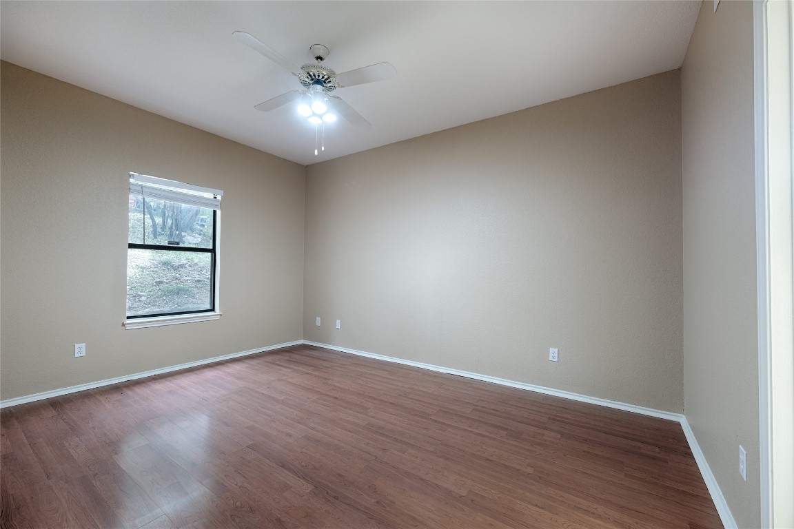 4711 Spicewood Springs Road, Unit 173 Austin, TX 78759 - Photo 12 of 19 an empty room with wooden floor and windows