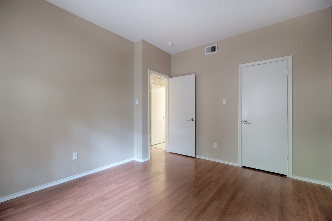 4711 Spicewood Springs Road, Unit 173 Austin, TX 78759 - Photo 16 of 19 a view of an empty room with wooden floor