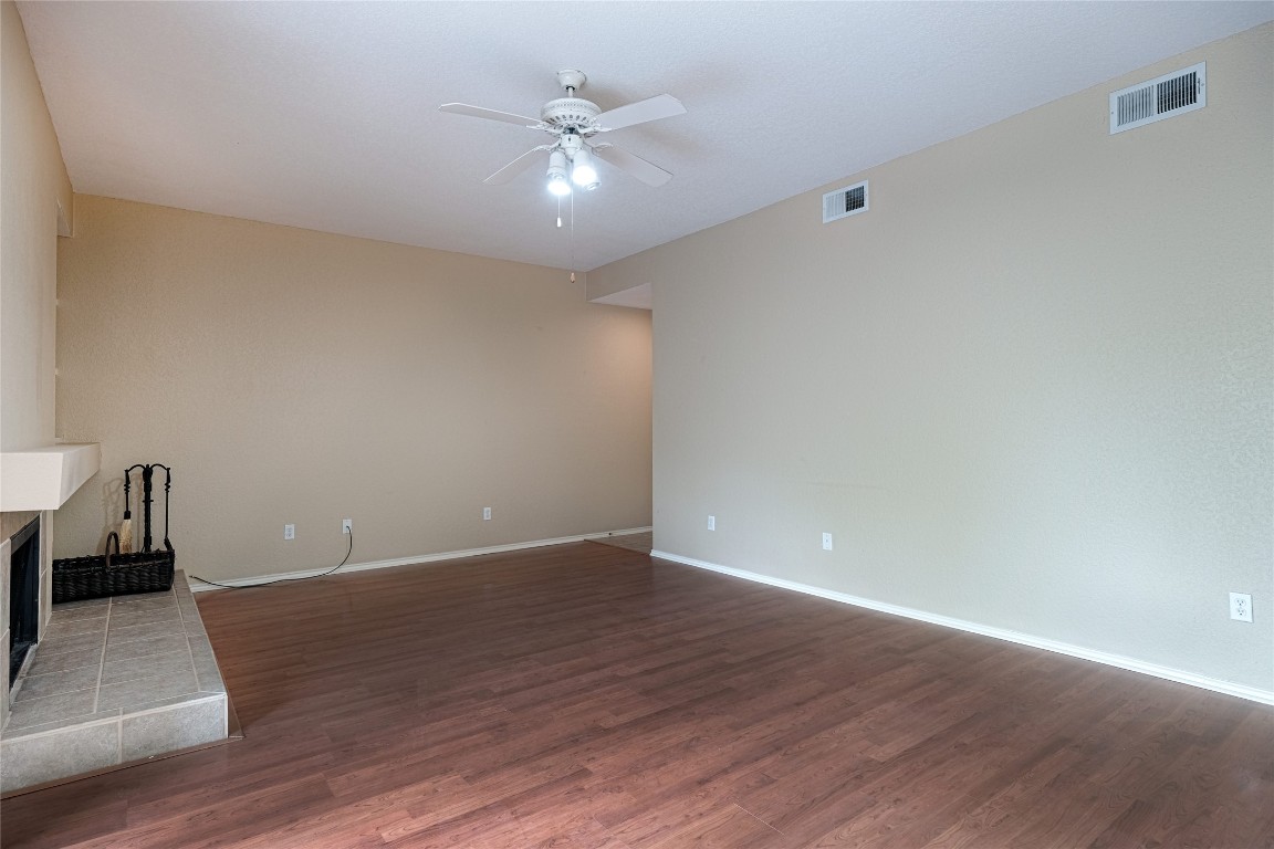 4711 Spicewood Springs Road, Unit 173 Austin, TX 78759 - Photo 2 of 19 a view of an empty room with wooden floor and a ceiling fan