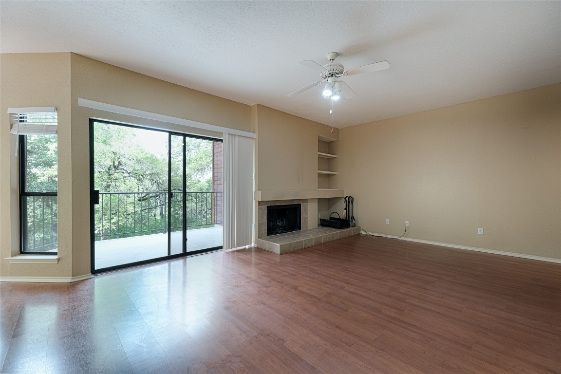 4711 Spicewood Springs Road, Unit 173 Austin, TX 78759 - Photo 3 of 19 a view of an empty room with a window and wooden floor