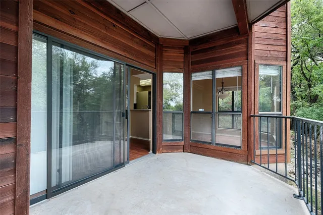 a view of a room with wooden floor and balcony