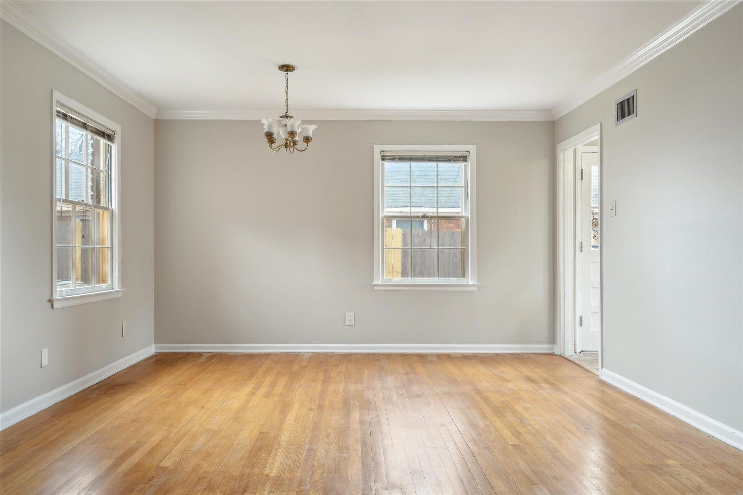 1072 Ivy Road Memphis, TN 38117 - Photo 15 of 35 a view of empty room with wooden floor and windows