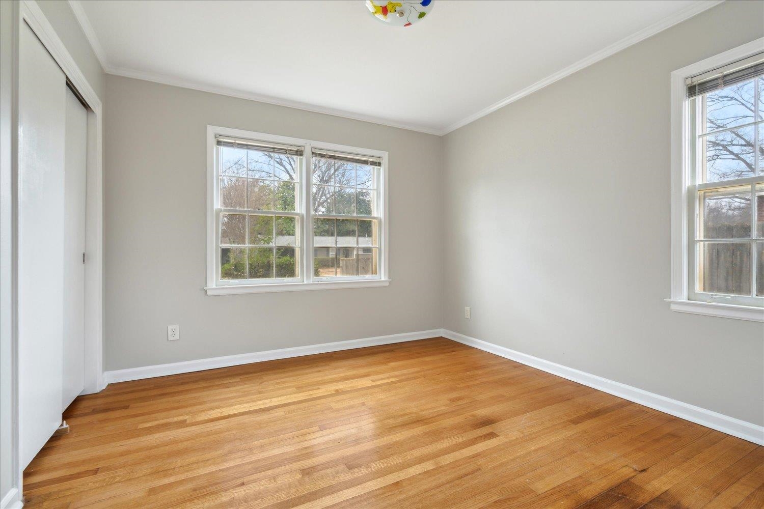 1072 Ivy Road Memphis, TN 38117 - Photo 18 of 35 Unfurnished bedroom with crown molding, light hardwood / wood-style floors, and a closet