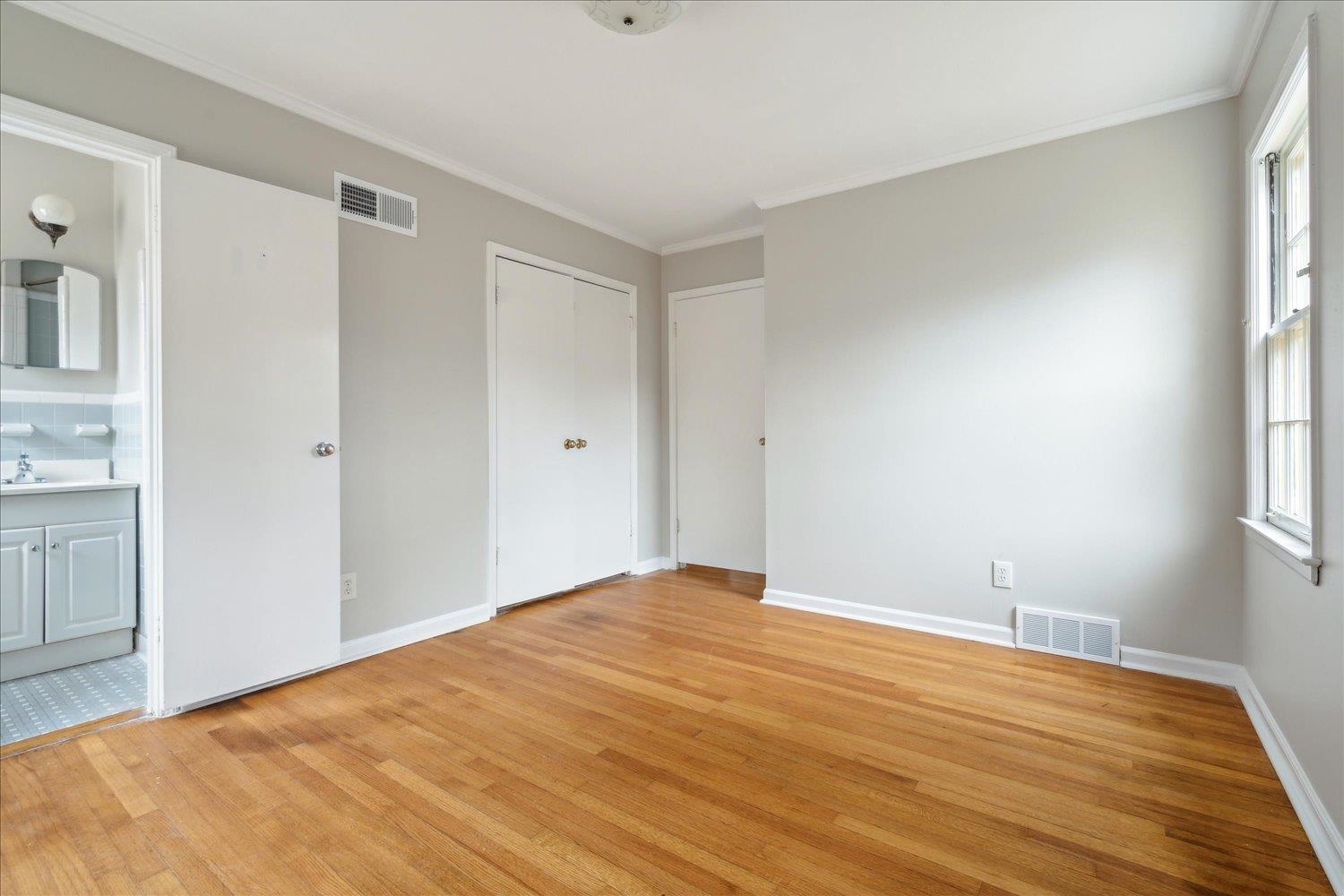 1072 Ivy Road Memphis, TN 38117 - Photo 20 of 35 a view of empty room with wooden floor and fan