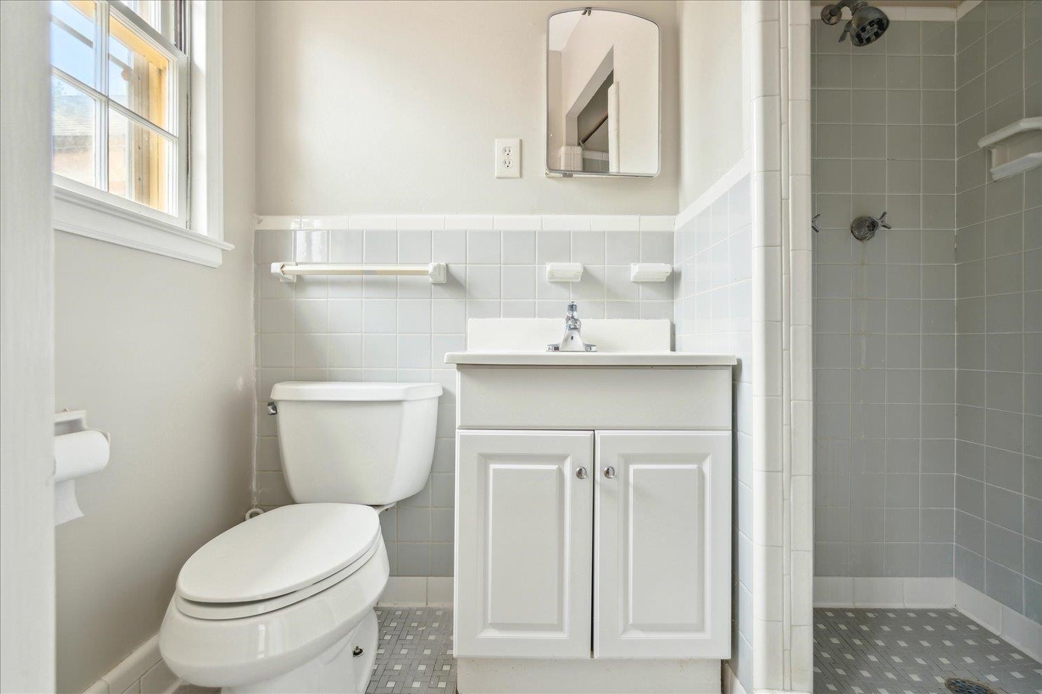 1072 Ivy Road Memphis, TN 38117 - Photo 21 of 35 a bathroom with a sink a toilet and a mirror