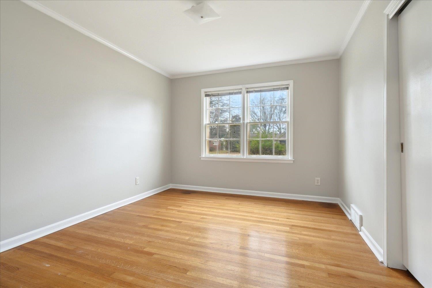 1072 Ivy Road Memphis, TN 38117 - Photo 23 of 35 an empty room with wooden floor and windows