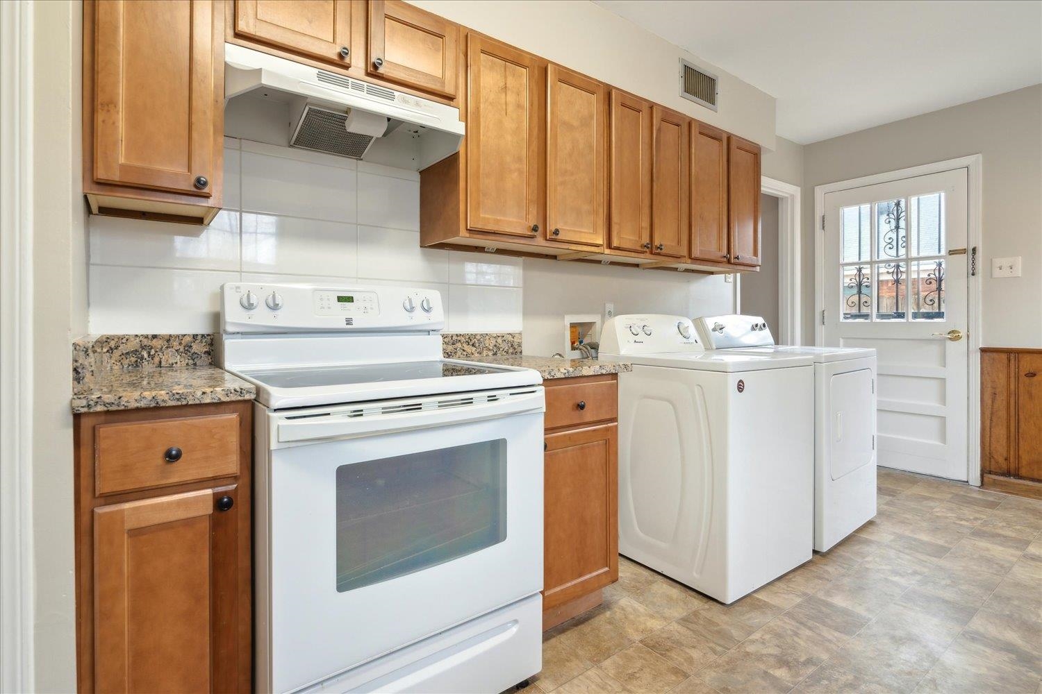 1072 Ivy Road Memphis, TN 38117 - Photo 9 of 35 Kitchen featuring electric stove, light stone countertops, and washer and dryer