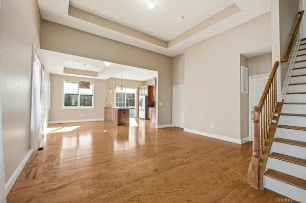 a view of an entryway with wooden floor and a livingroom view
