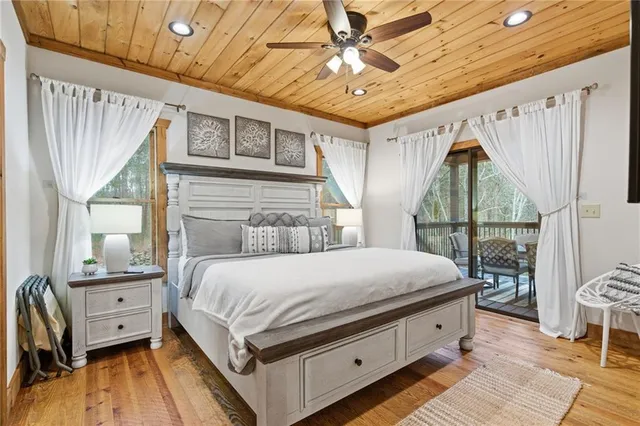 a bedroom with a bed a chandelier and dresser