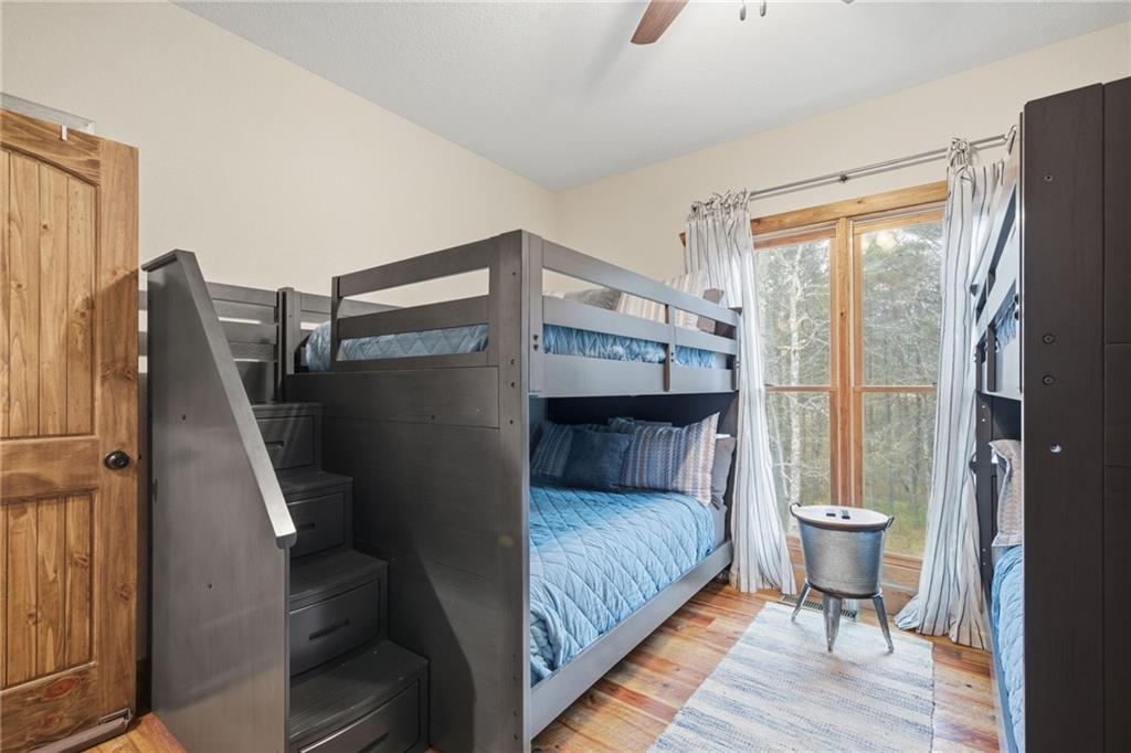 41 Bunks Way Morganton, GA 30560 - Photo 21 of 33 a bedroom with a bed and wooden floor