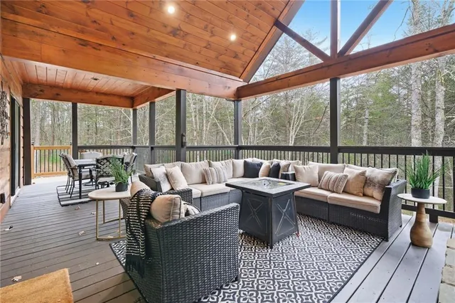 a living room with furniture and a floor to ceiling window