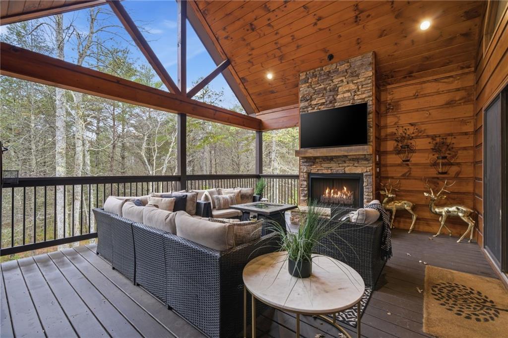 41 Bunks Way Morganton, GA 30560 - Photo 24 of 33 a living room with furniture a fireplace a flat screen tv and floor to ceiling window