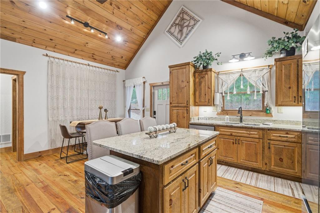 41 Bunks Way Morganton, GA 30560 - Photo 8 of 33 a kitchen with a stove a sink dishwasher and a dining table with wooden floor