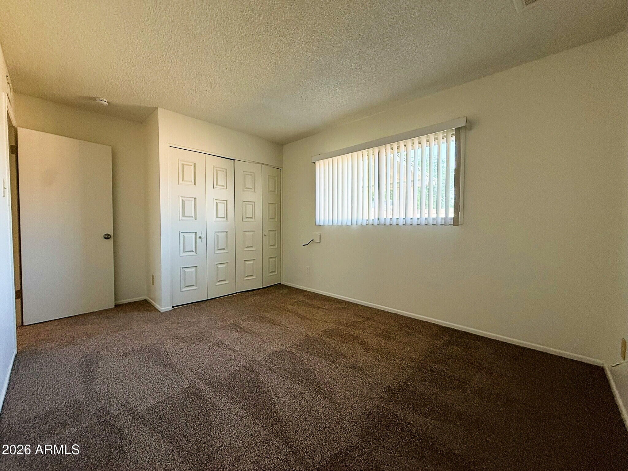 5208 West Calavar Road Glendale, AZ 85306 - Photo 16 of 39 an empty room with windows