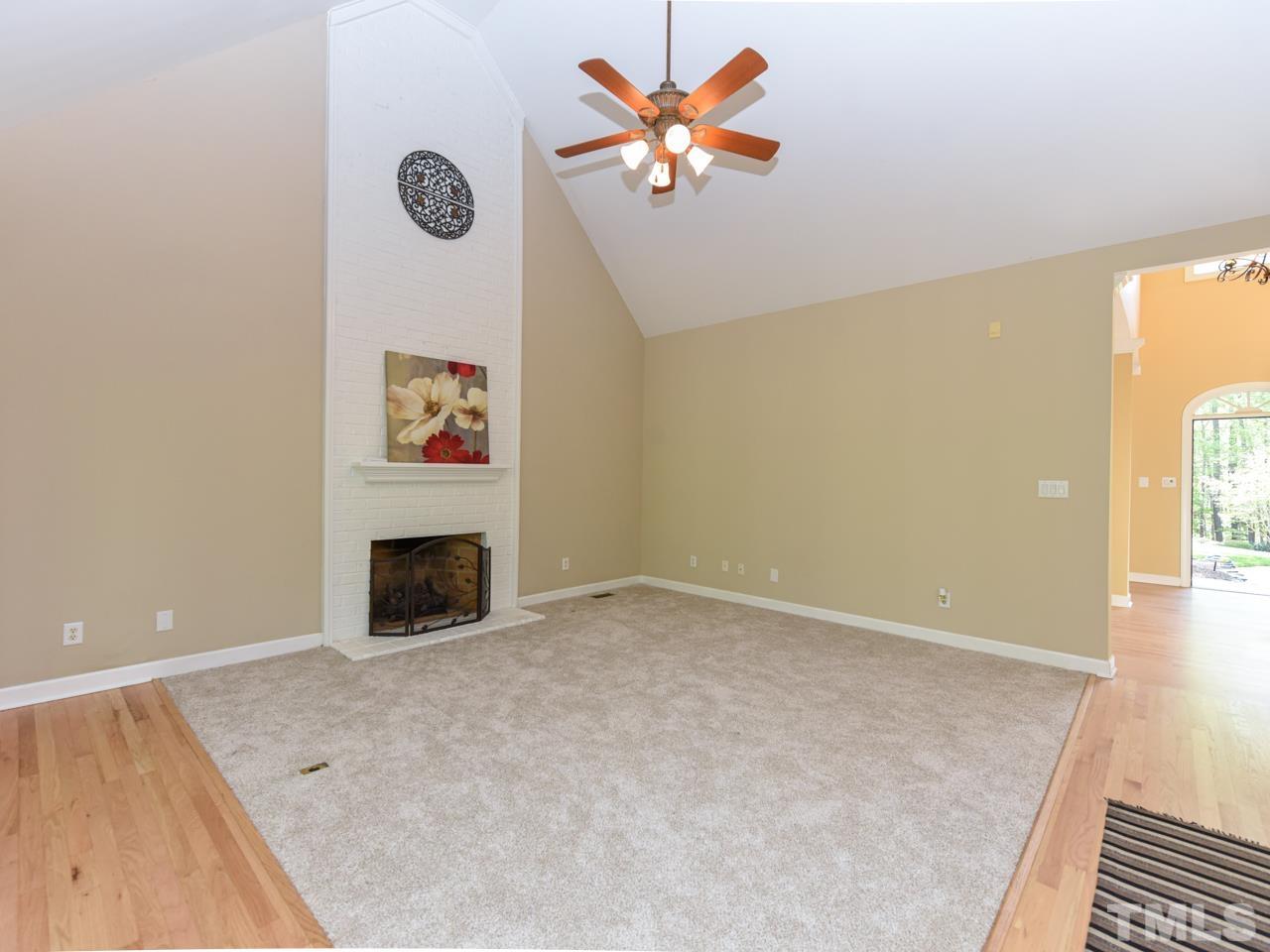 5820 Orchid Valley Road Raleigh, NC 27613 - Photo 11 of 31 an empty room with a fireplace and a window