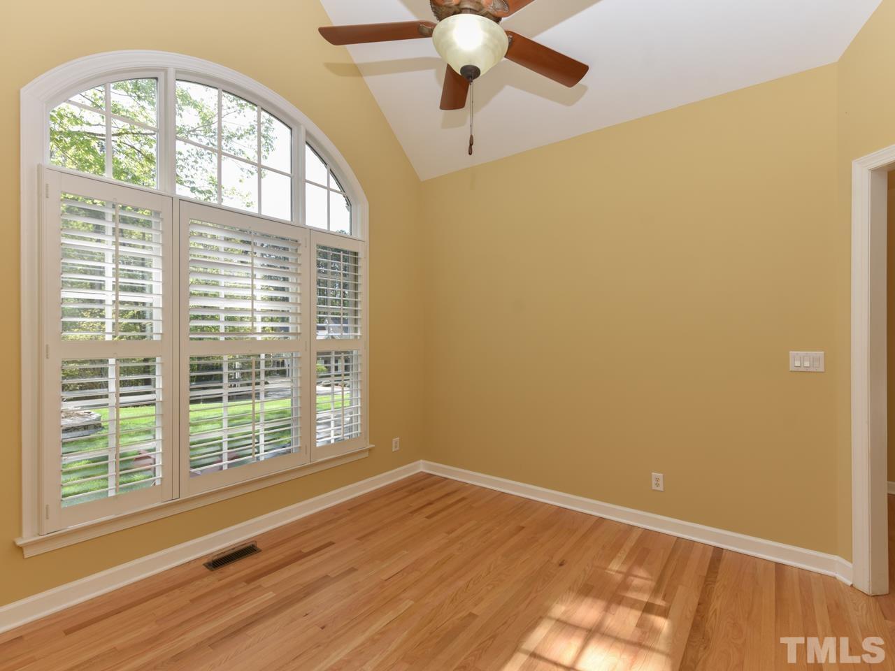 5820 Orchid Valley Road Raleigh, NC 27613 - Photo 14 of 31 a view of an empty room with wooden floor and a window