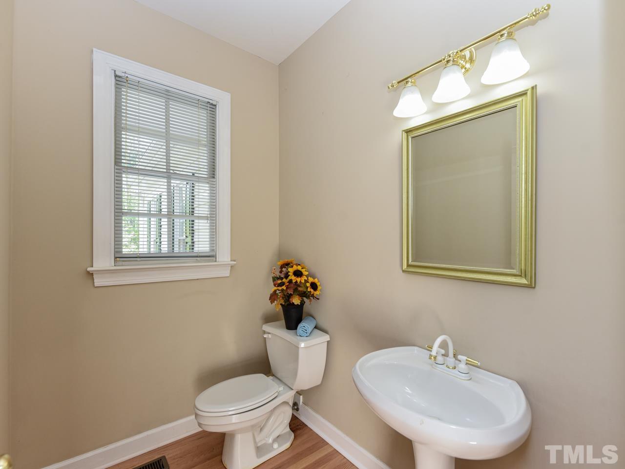 5820 Orchid Valley Road Raleigh, NC 27613 - Photo 15 of 31 a bathroom with a toilet sink and mirror