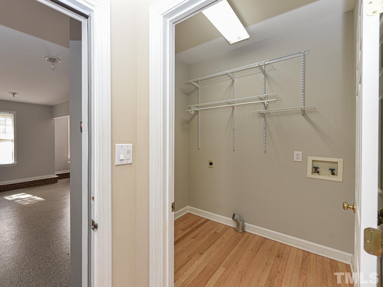 5820 Orchid Valley Road Raleigh, NC 27613 - Photo 16 of 31 a view of an empty room with wooden floor and a window