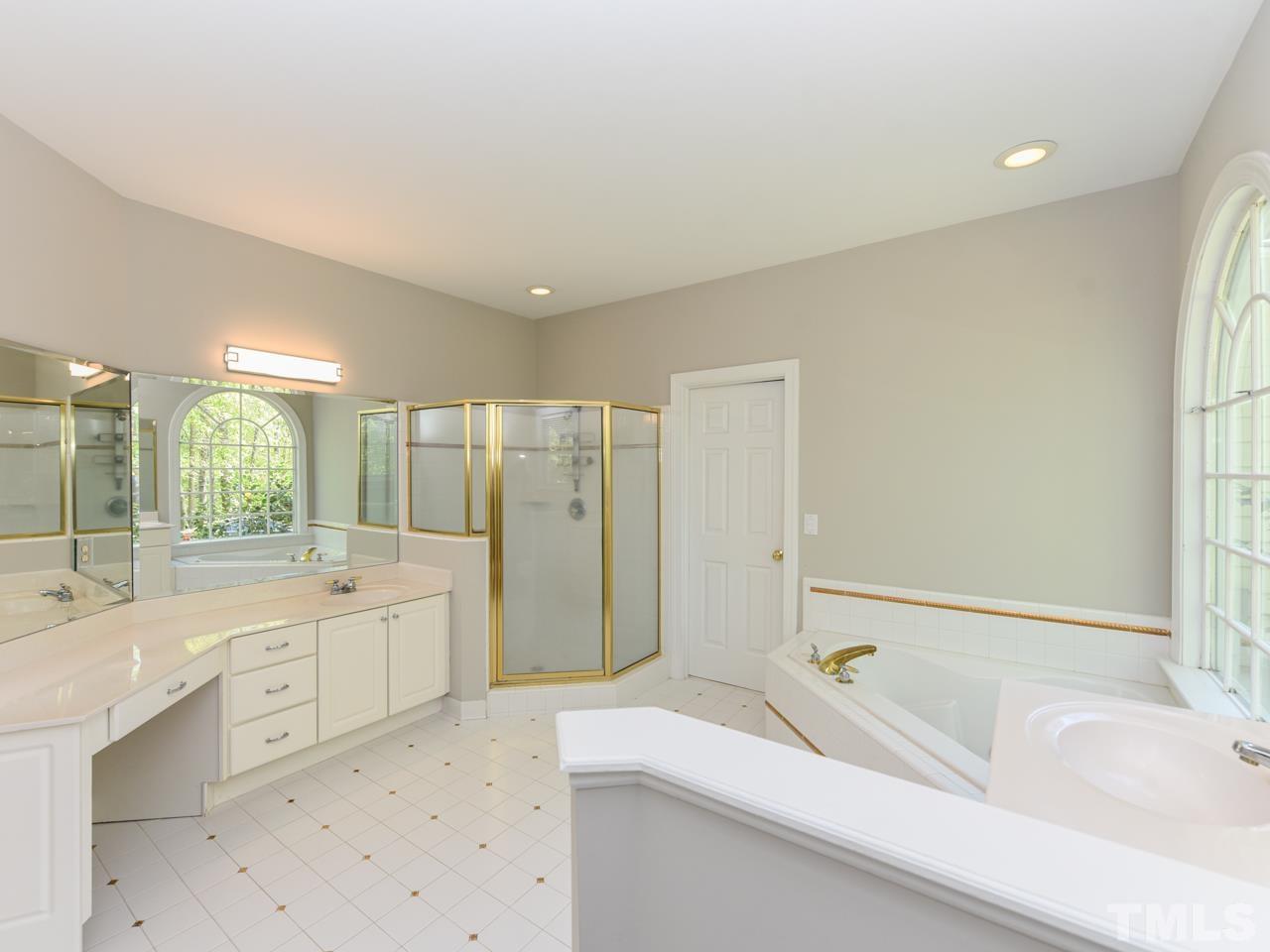 5820 Orchid Valley Road Raleigh, NC 27613 - Photo 19 of 31 a bathroom with a tub sink and mirror