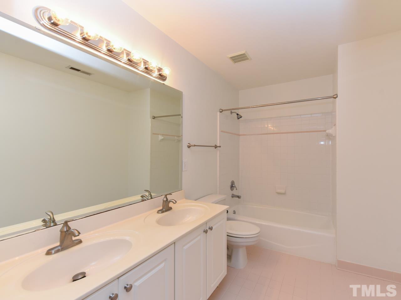 5820 Orchid Valley Road Raleigh, NC 27613 - Photo 24 of 31 a bathroom with a double vanity sink toilet mirror and shower