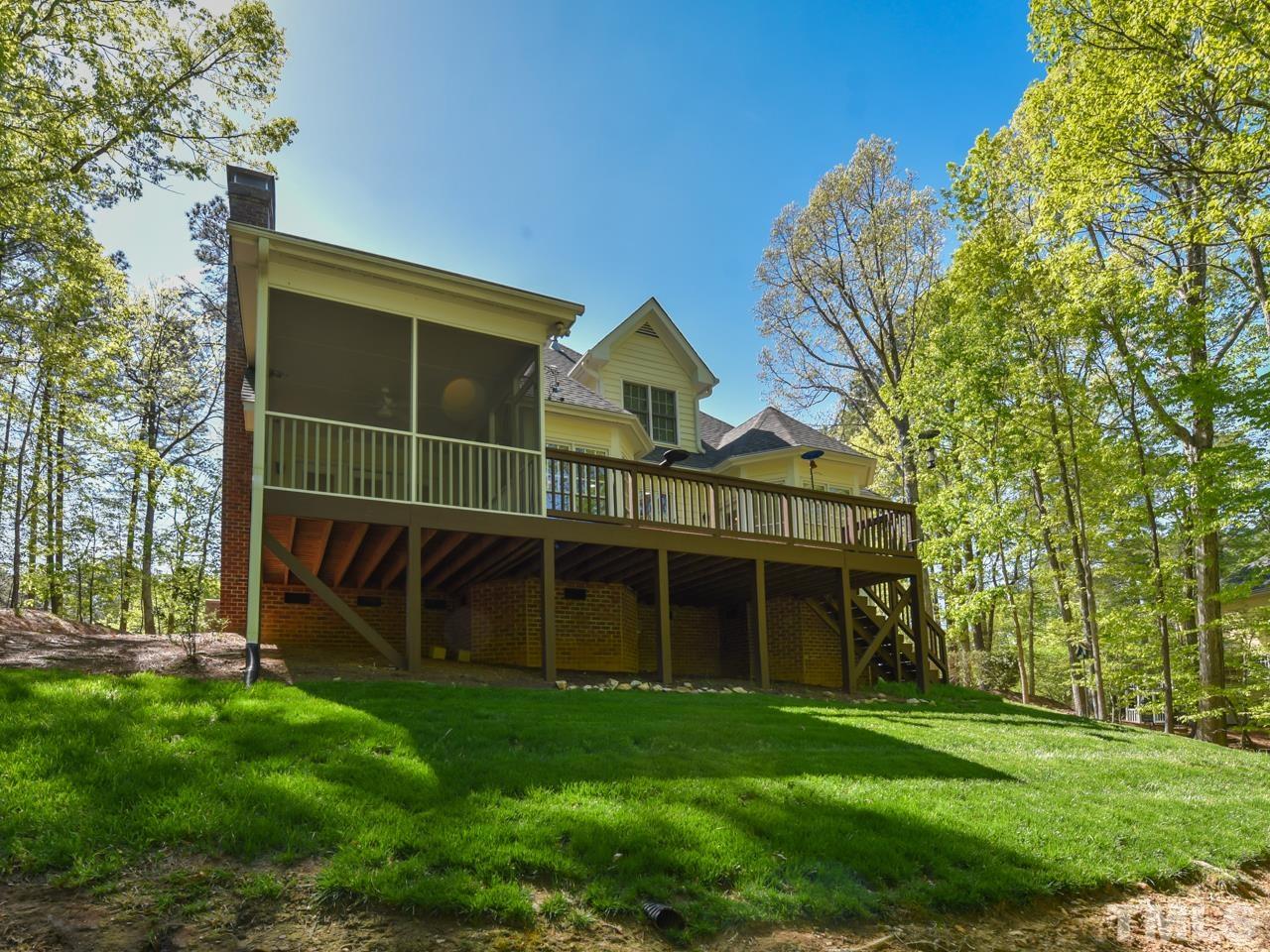 5820 Orchid Valley Road Raleigh, NC 27613 - Photo 29 of 31 a view of a house with a yard and a large tree