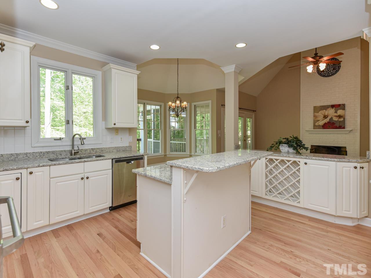 5820 Orchid Valley Road Raleigh, NC 27613 - Photo 5 of 31 a large kitchen with stainless steel appliances granite countertop a large window a sink and cabinets