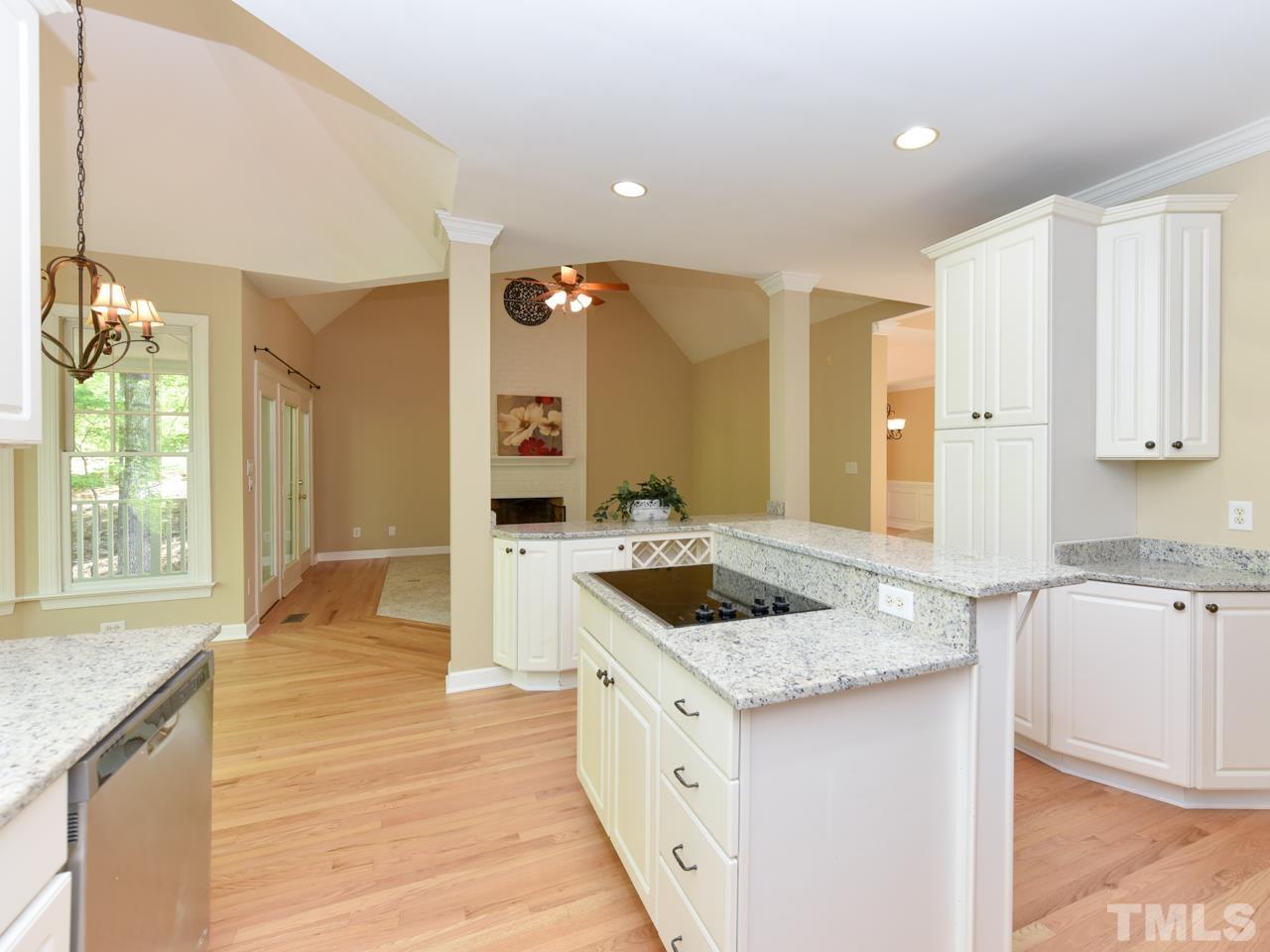 5820 Orchid Valley Road Raleigh, NC 27613 - Photo 7 of 31 a kitchen with granite countertop a sink stove and cabinets