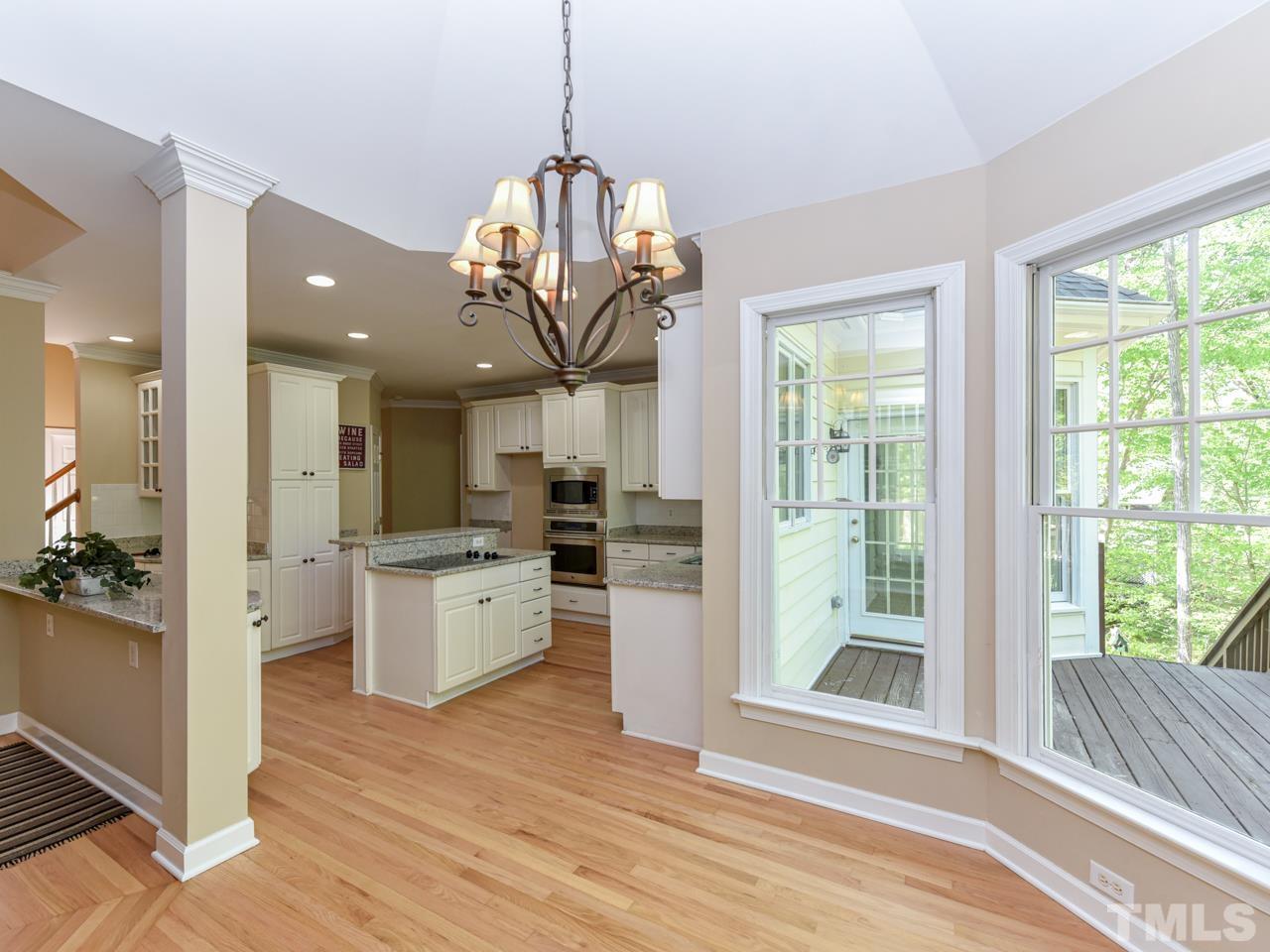 5820 Orchid Valley Road Raleigh, NC 27613 - Photo 8 of 31 a view of a kitchen with granite countertop stainless steel appliances and wooden floor