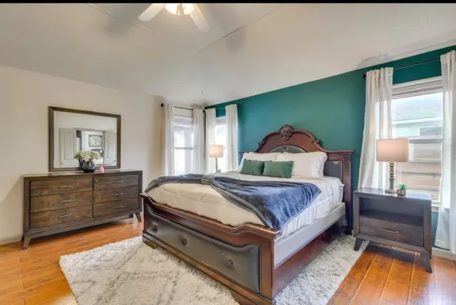 a spacious bedroom with a bed and window