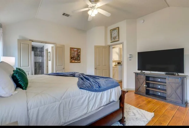 a bedroom with a bed and a flat screen television