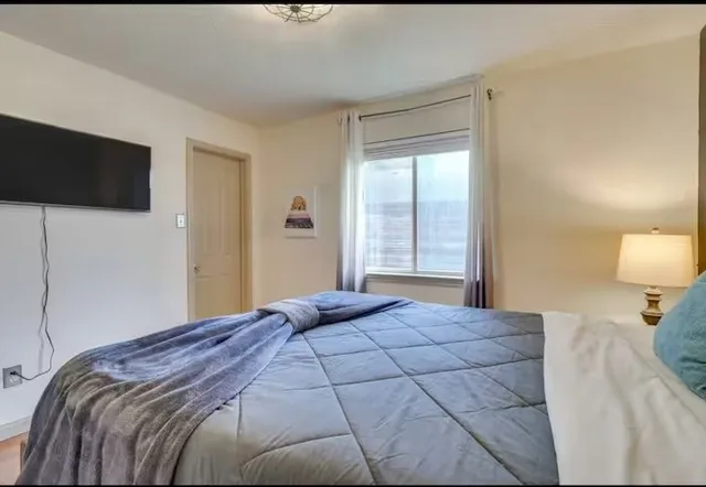 a bedroom with a bed and a window
