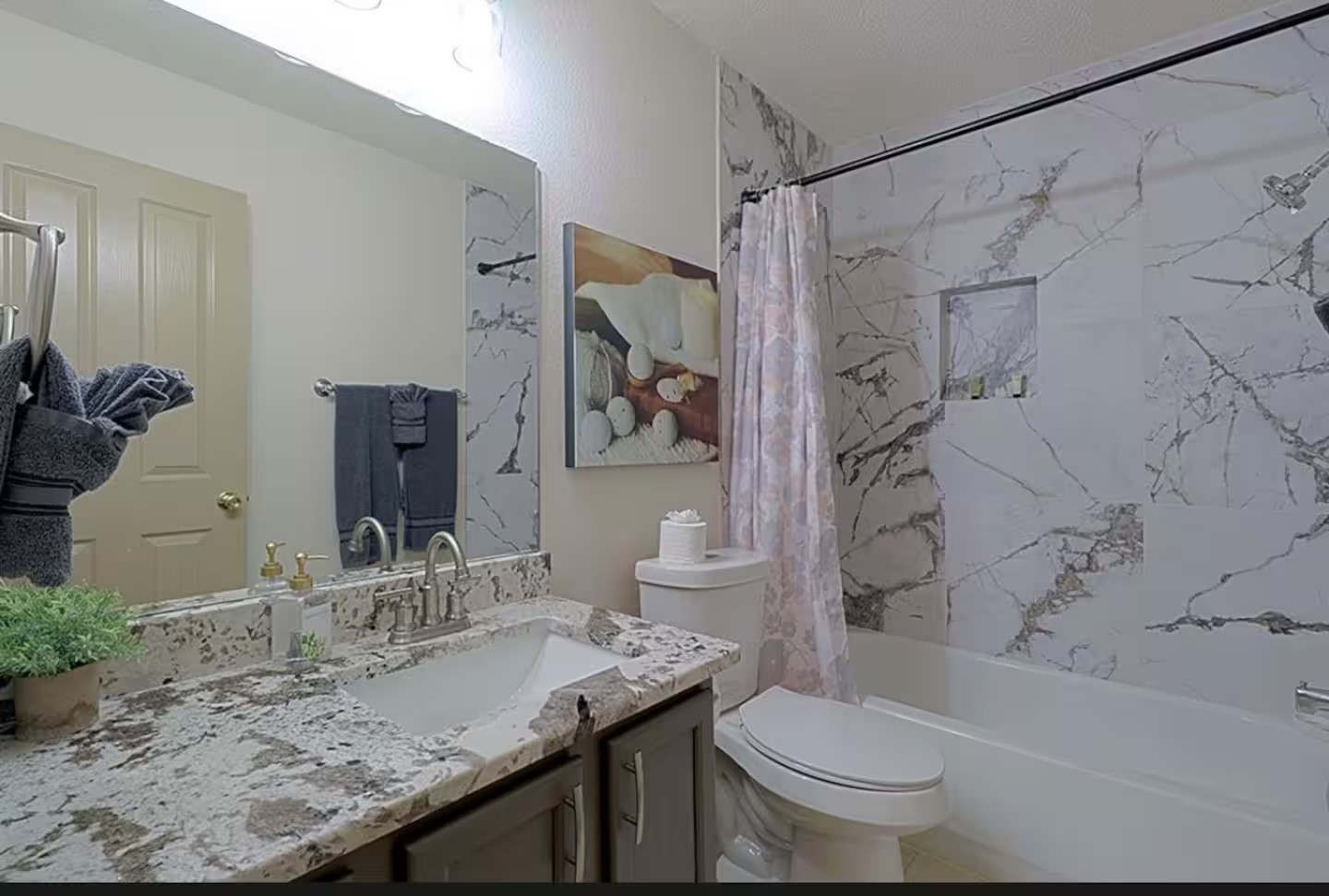 1305 Marigold Way Pflugerville, TX 78660 - Photo 19 of 22 a bathroom with a granite countertop sink toilet and shower