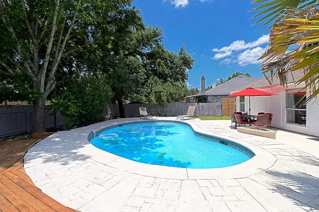 a view of a swimming pool with a lounge chairs