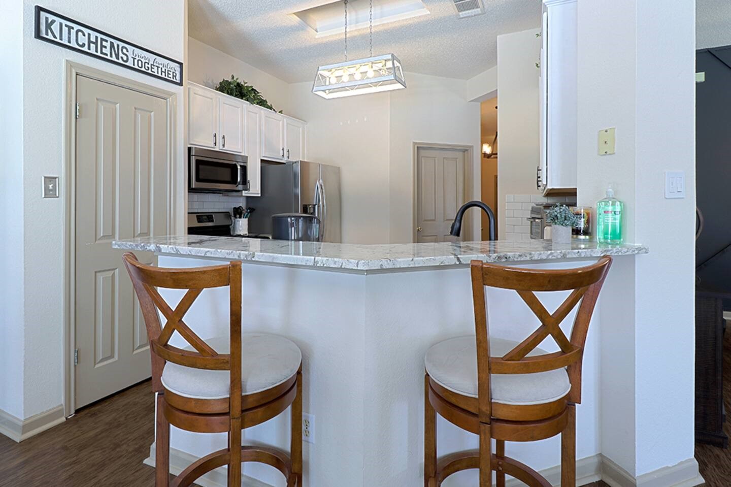 1305 Marigold Way Pflugerville, TX 78660 - Photo 5 of 22 a kitchen with stainless steel appliances granite countertop a dining table and chairs