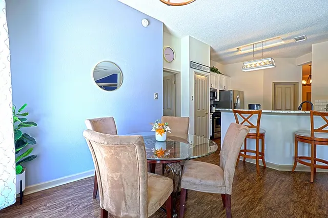 a view of a dining room with furniture and wooden floor