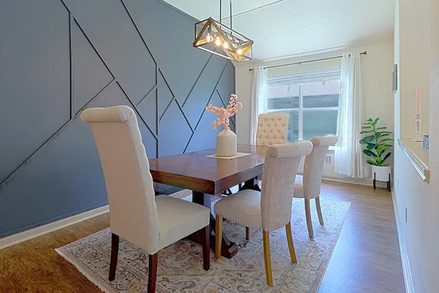a view of a dining room with furniture window and wooden floor
