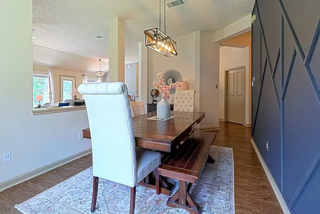 a dining room with furniture and wooden floor