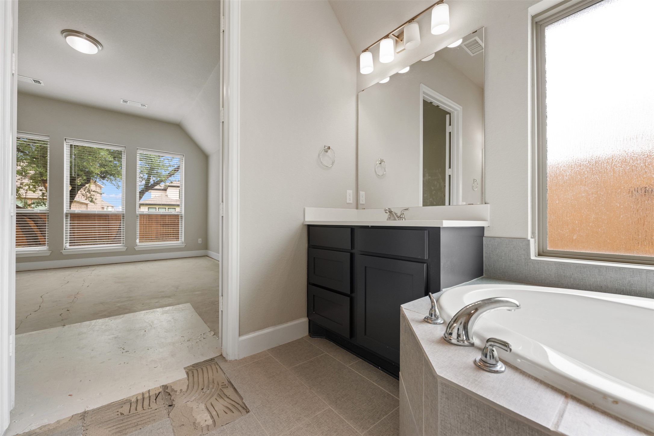 104 Anejo Bluff Georgetown, TX 78628 - Photo 30 of 40 a bathroom with a tub sink and mirror