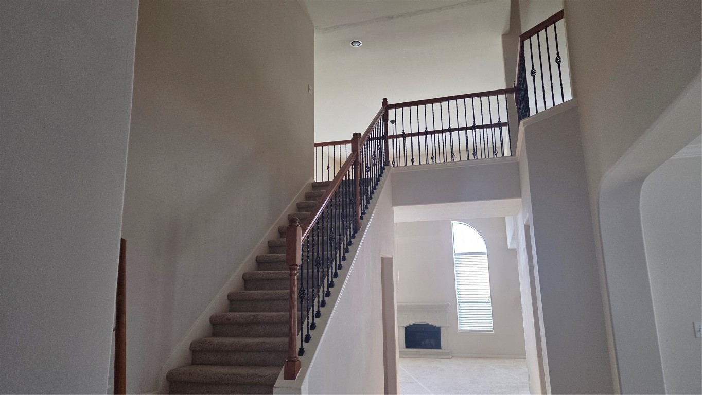 2103 Trinity Manor Lane Richmond, TX 77469 - Photo 22 of 30 a view of staircase with wooden floor and white walls