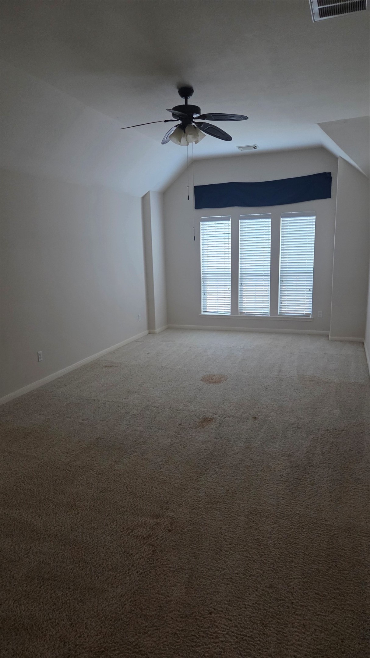 2103 Trinity Manor Lane Richmond, TX 77469 - Photo 23 of 30 an empty room with a ceiling fan and window